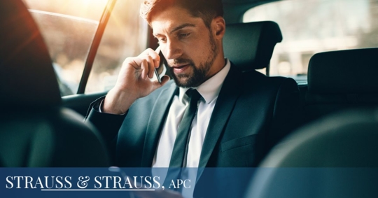 Businessman in a vehicle on his phone